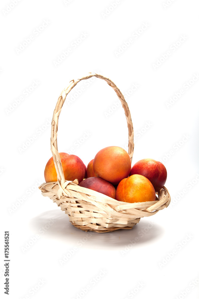 Basket full of fresh peaches isolated on white background Basket full of fresh peaches isolated on white background