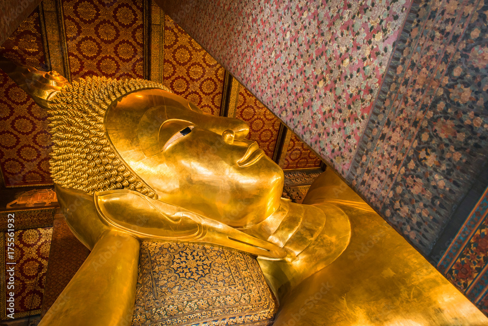 Reclining Buddha gold statue face. Wat Pho in Bangkok, Thailand.