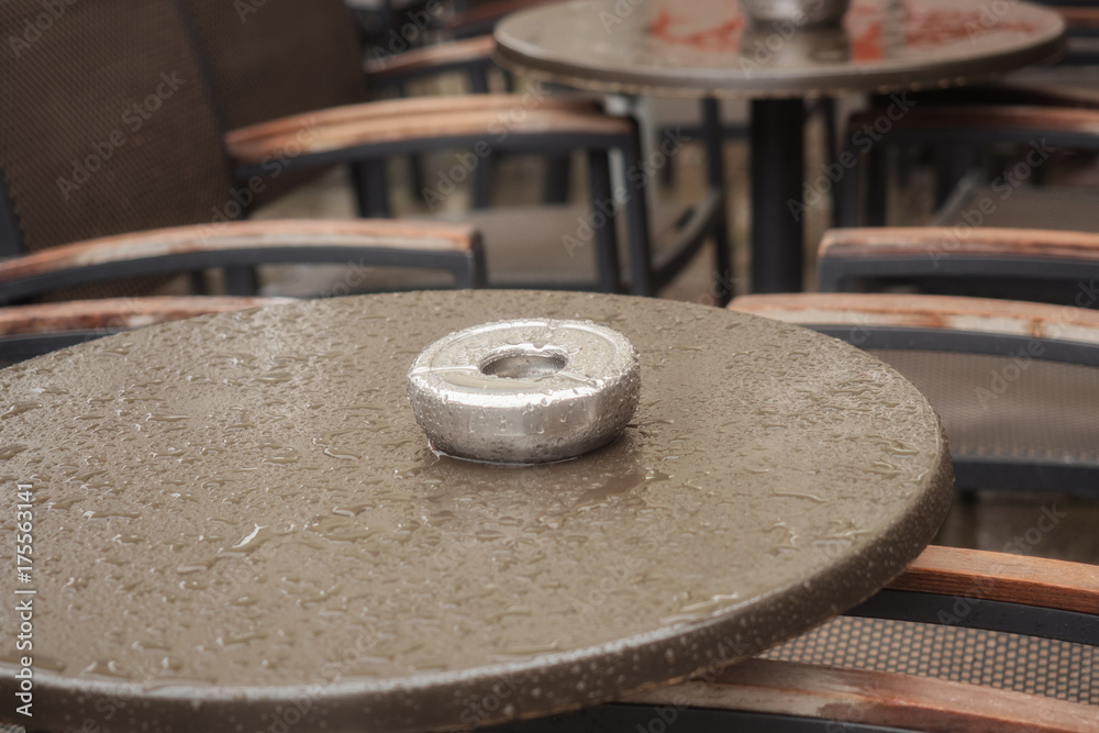 Wet table of a street cafe with ashtray Wet table of a street cafe with ashtray
