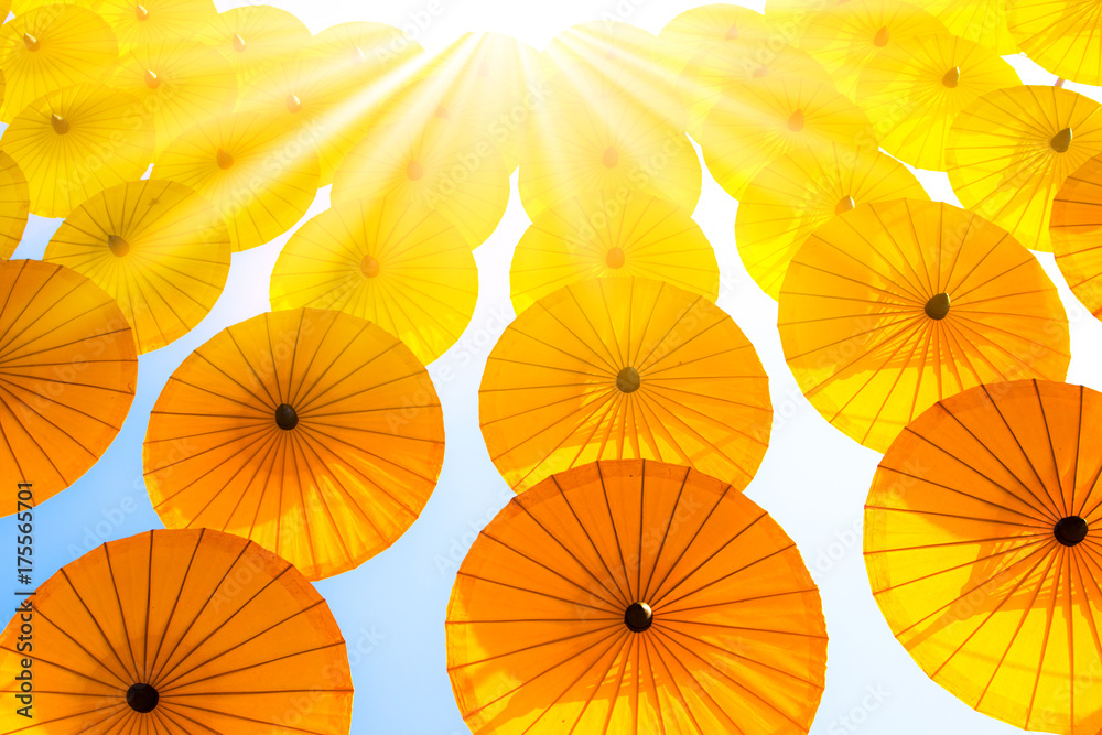 Naklejka premium Sunlight Pattern Yellow umbrellas on blue sky.