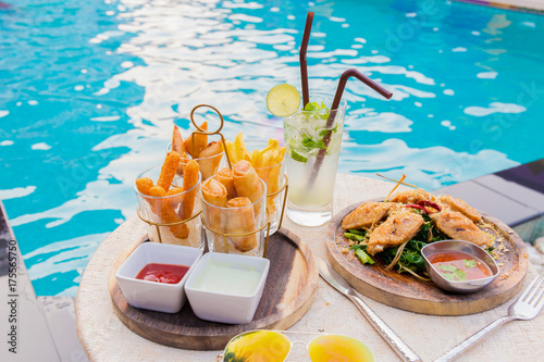 mix snack break with margarita cocktail near the swimming pool in relax time.