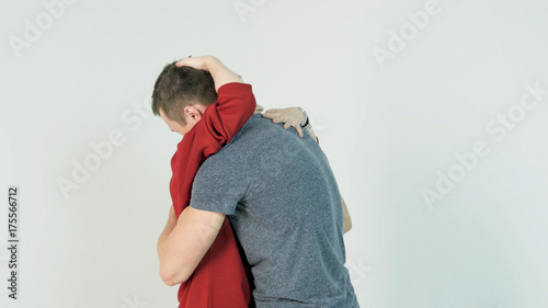 Young man hugging girlfriend. Young couple embraces after a long separation, on a white background © Media Whale Stock