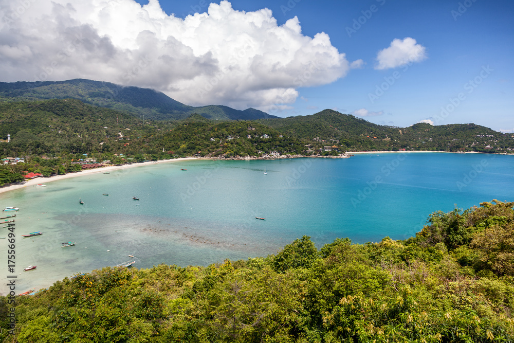 Beautiful tropical beach with blue water and green hills, top view