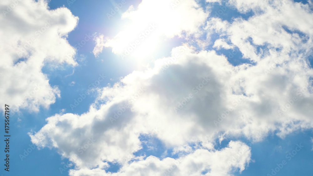 Fototapeta premium Beautiful cloudscape with large, building clouds and sunrise breaking through cloud mass