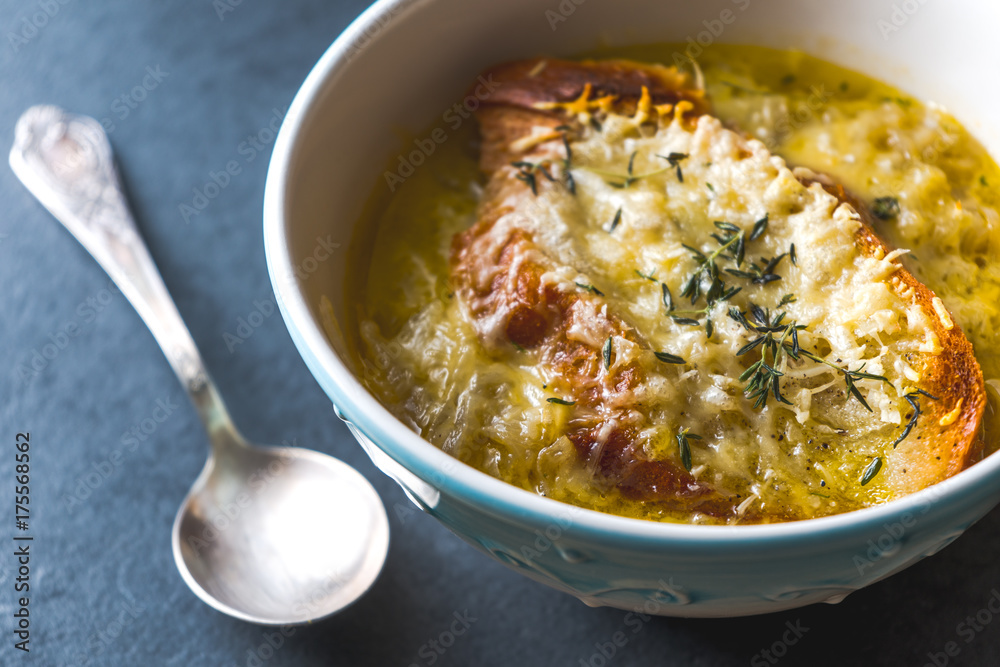 French onion soup with cheese and croutons and a spoon French onion soup with cheese and croutons and a spoon