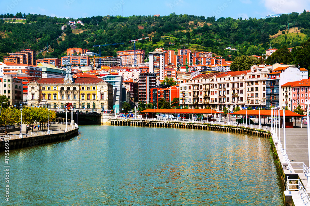 City downtown with a Nevion River and promenade area in Bilbao, Spain