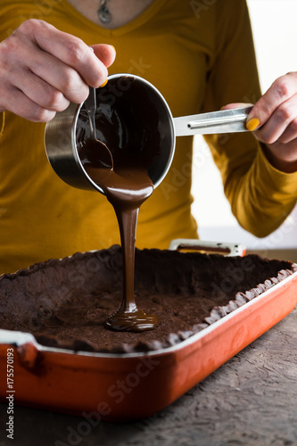 Hot chocolate from a saute pan is poured into the dough