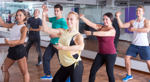 Happy beginner dancers learning zumba elements