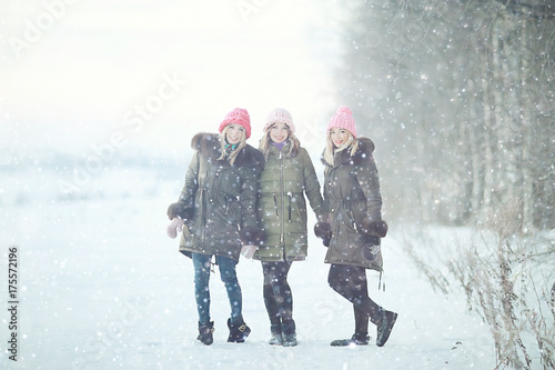 Group of a stylish young girlfriends walking outdoors in winter