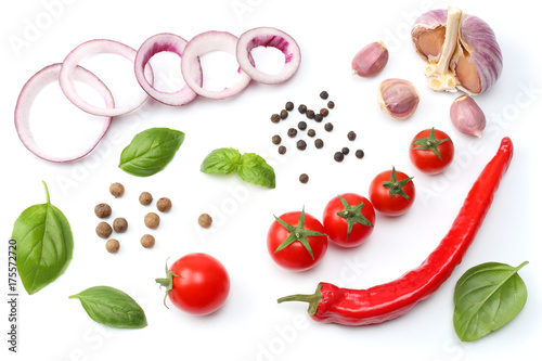 Fototapeta Naklejka Na Ścianę i Meble -  sliced red onion, red hot chili pepper, tomato, garlic and spices isolated on white background. top view