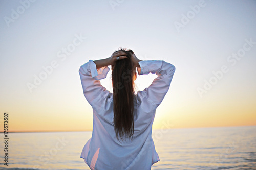 Girl at sea view from behind concept freedom rest happiness