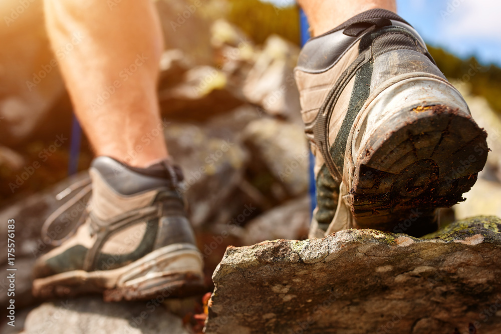 Hiking man with trekking boots on the trail Hiking man with trekking boots on the trail
