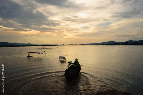 Vietnam landscape. Lake with elephant walking at sunset in Vietnam