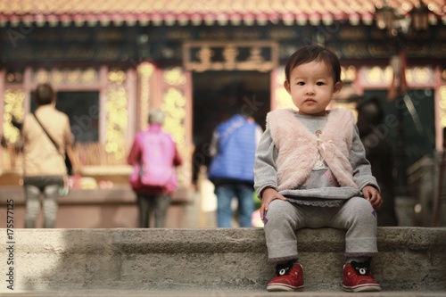 Photography little child sit on stair case of chinese temple in hongkong