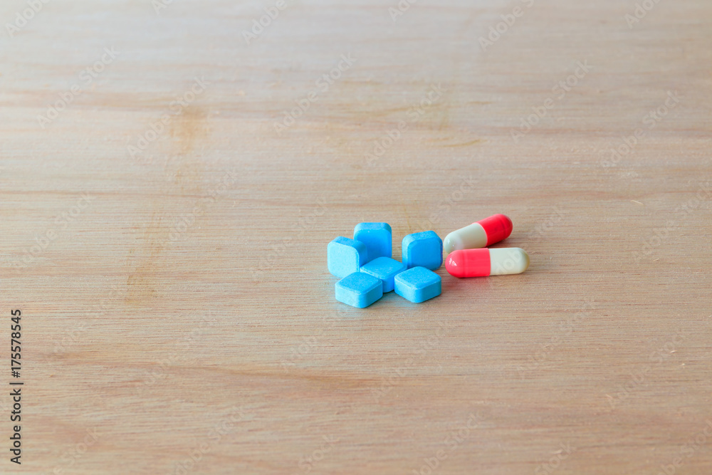 pills blue and capsule On wooden floor with copy space add text ( high definition image ) pills blue and capsule On wooden floor with copy space add text ( high definition image )