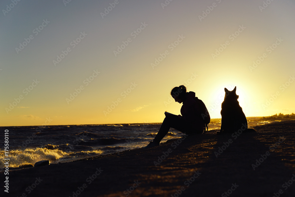 The girl with a dog on the coast