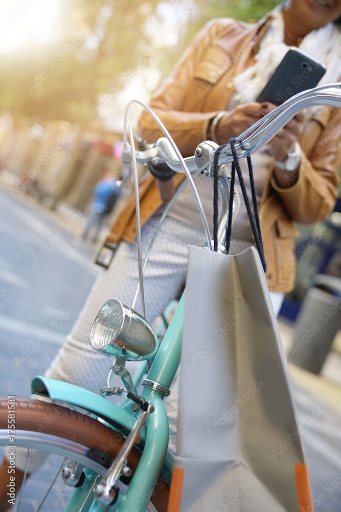 Senior woman using bike on shopping day