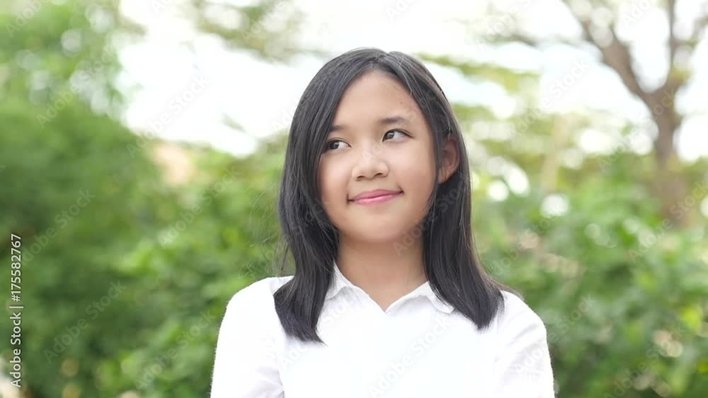 Beautiful asian girl looking up on nature background slow motion 