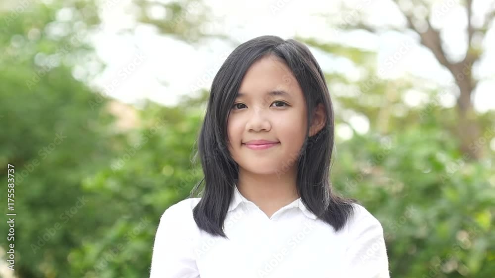 Beautiful asian girl looking up on nature background slow motion Beautiful asian girl looking up on nature background slow motion