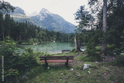 Empty bench near alpine mountain lake