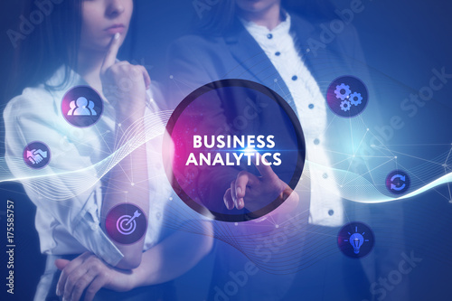 The concept of business, technology, the Internet and the network. A team of business women working on the virtual screen of the future and see the inscription: Business analytics