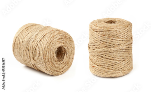 Two coil bobbins of burlap jute twine over white