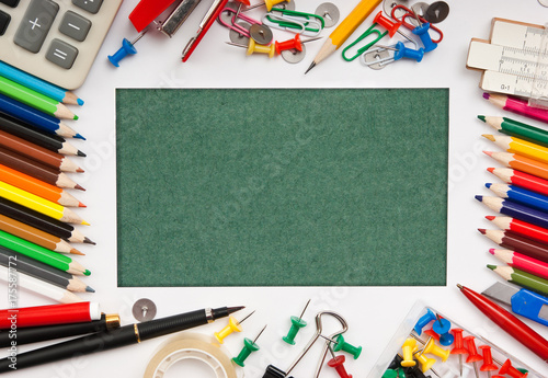 frame from a variety of office supplies and green paper for notes