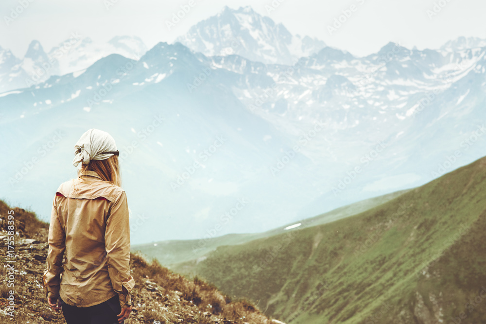 Naklejka premium Woman traveler hiking at mountains landscape Travel Lifestyle wanderlust adventure concept summer vacations outdoor into the wild