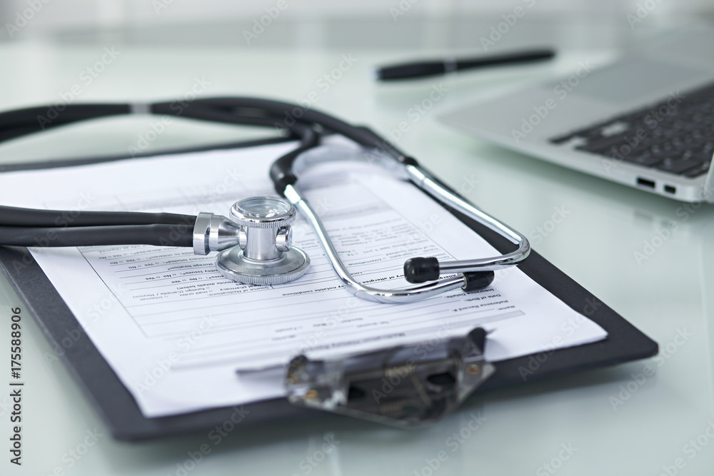 Medicine doctor's working table. Focus on stethoscope 