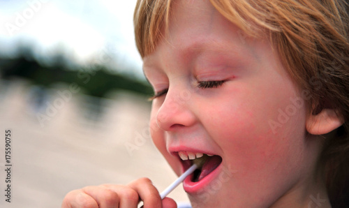 Portrait of a boy with lollipop