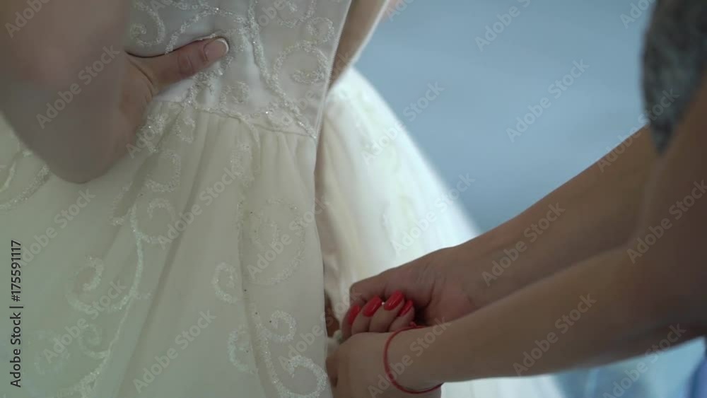 Zipping up bridal dress closeup Zipping up bridal dress closeup