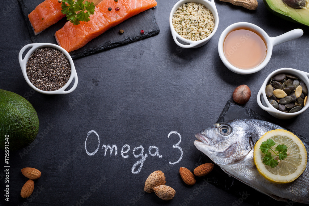 Black slate table with product rich in omega 3 and vitamin D. Written