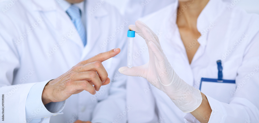 Team of scientific researchers in laboratory studying substances or blood sample. New vaccine for pharmacology industry is s almost ready. Medicine and science concept Team of scientific researchers in laboratory studying substances or blood sample. New vaccine for pharmacology industry is s almost ready. Medicine and science concept