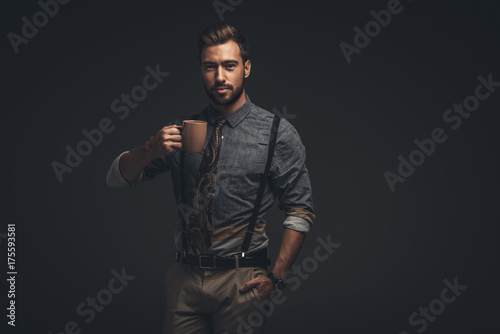handsome man holding cup