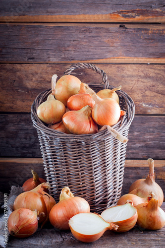 Onions in a wicker basket in a rustic style, selective focus photo