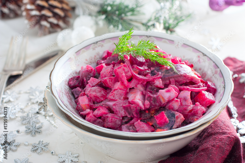 Salad with beets and herring in festive Christmas decorations, horizontal