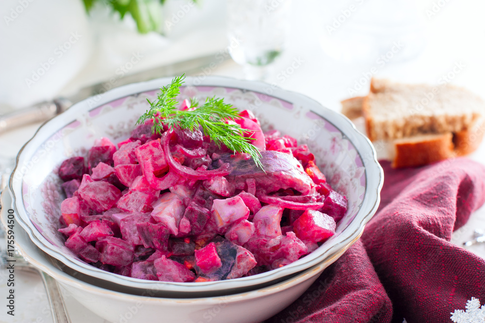 German traditional salad with beets, apple, egg and herring in a bowl, selective focus German traditional salad with beets, apple, egg and herring in a bowl, selective focus