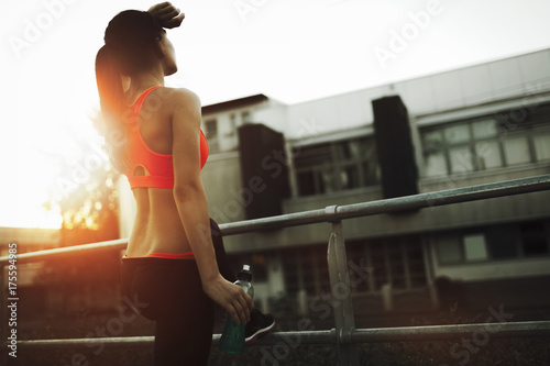 Beautiful female jogger tired after running