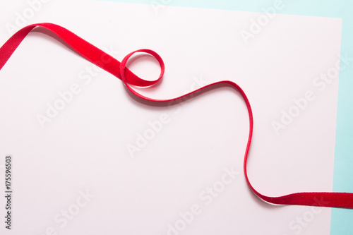 Red ribbon on paper background
