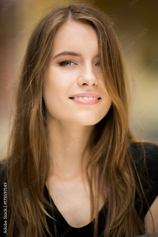 Beautiful woman with long hair. Pretty girl smiling to camera. Stock Photo