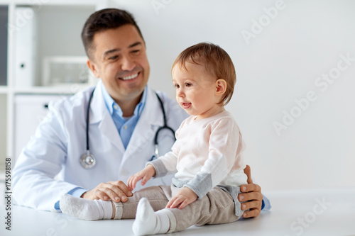 happy doctor or pediatrician with baby at clinic