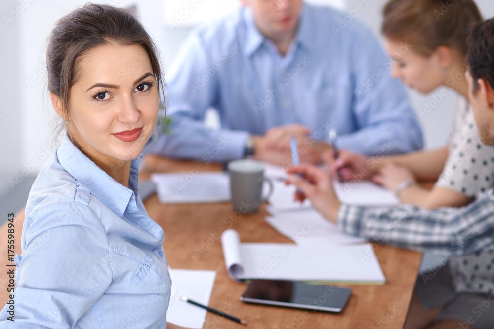 Beautiful business woman on the background of business people. Start up team.