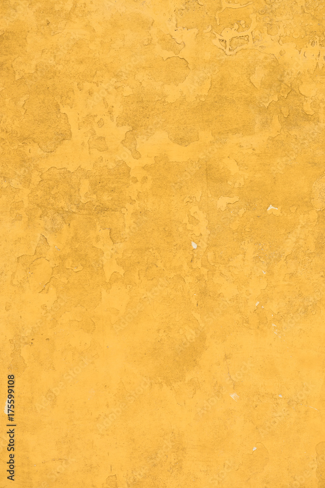 Old concrette wall covered in yellow painted weathered stucco texture background