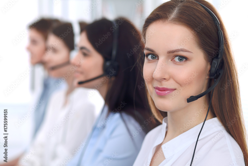 Call center operator.Young beautiful business woman in headset Call center operator.Young beautiful business woman in headset