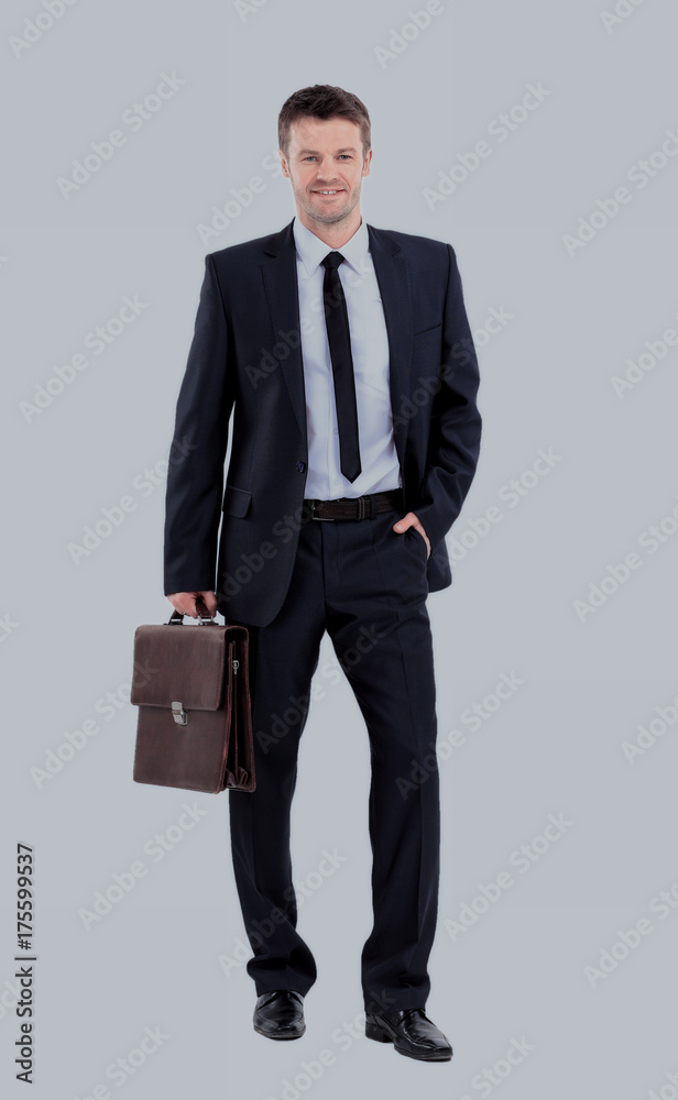 Portrait of an elegant handsome business man with suitcase on w Portrait of an elegant handsome business man with suitcase on w