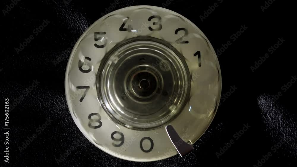 Dialing on an old rotary style telephone. Dialing 911 Emergency phone call. Close-up view.
Dialing on an old rotary style telephone. Dialing 911 Emergency phone call. Close-up view.