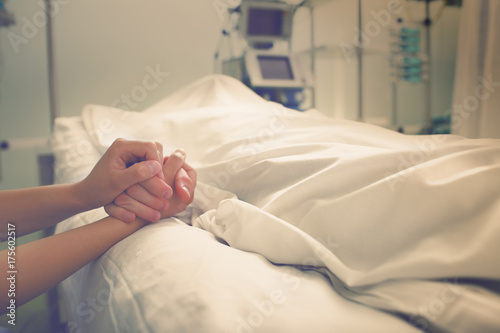 Woman mourns her husband, who died in a hospital photo