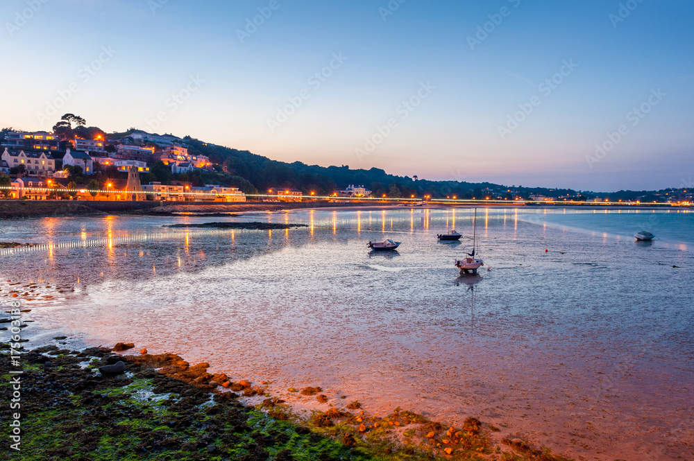 Coastline of Saint Aubin, Jersey, Channel Islands, UK at low tide and sunset