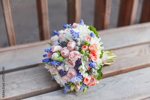 Bridal bouquet with roses, brunia and Muscari flowers. Traditional accessory for wedding.