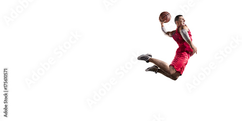 Basketball player makes slam dunk. Isolated basketball player on a white background. Player wears unbranded clothes. © Alex